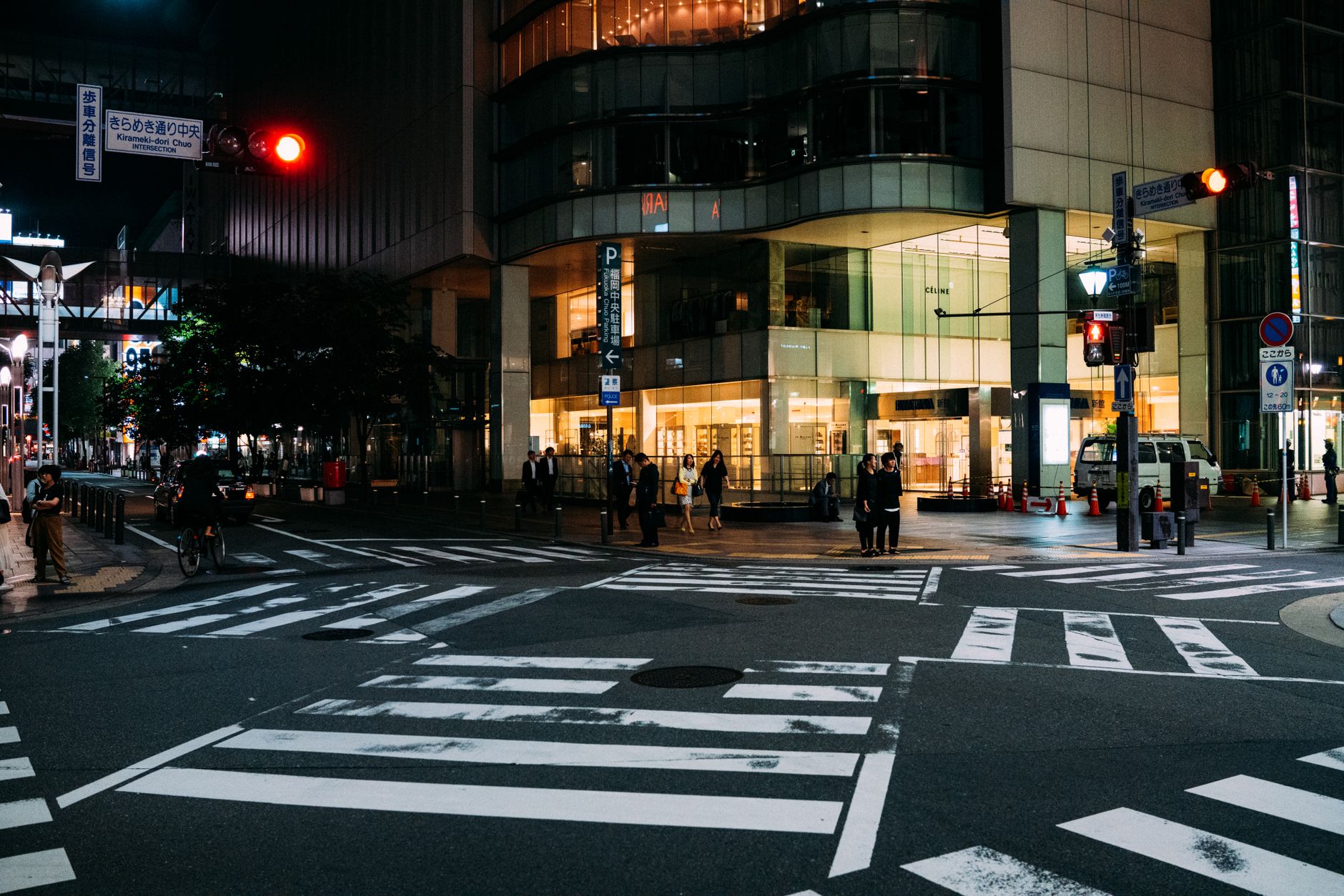Pedestrians, cyclists and vehicles moving through a signalized urban intersection