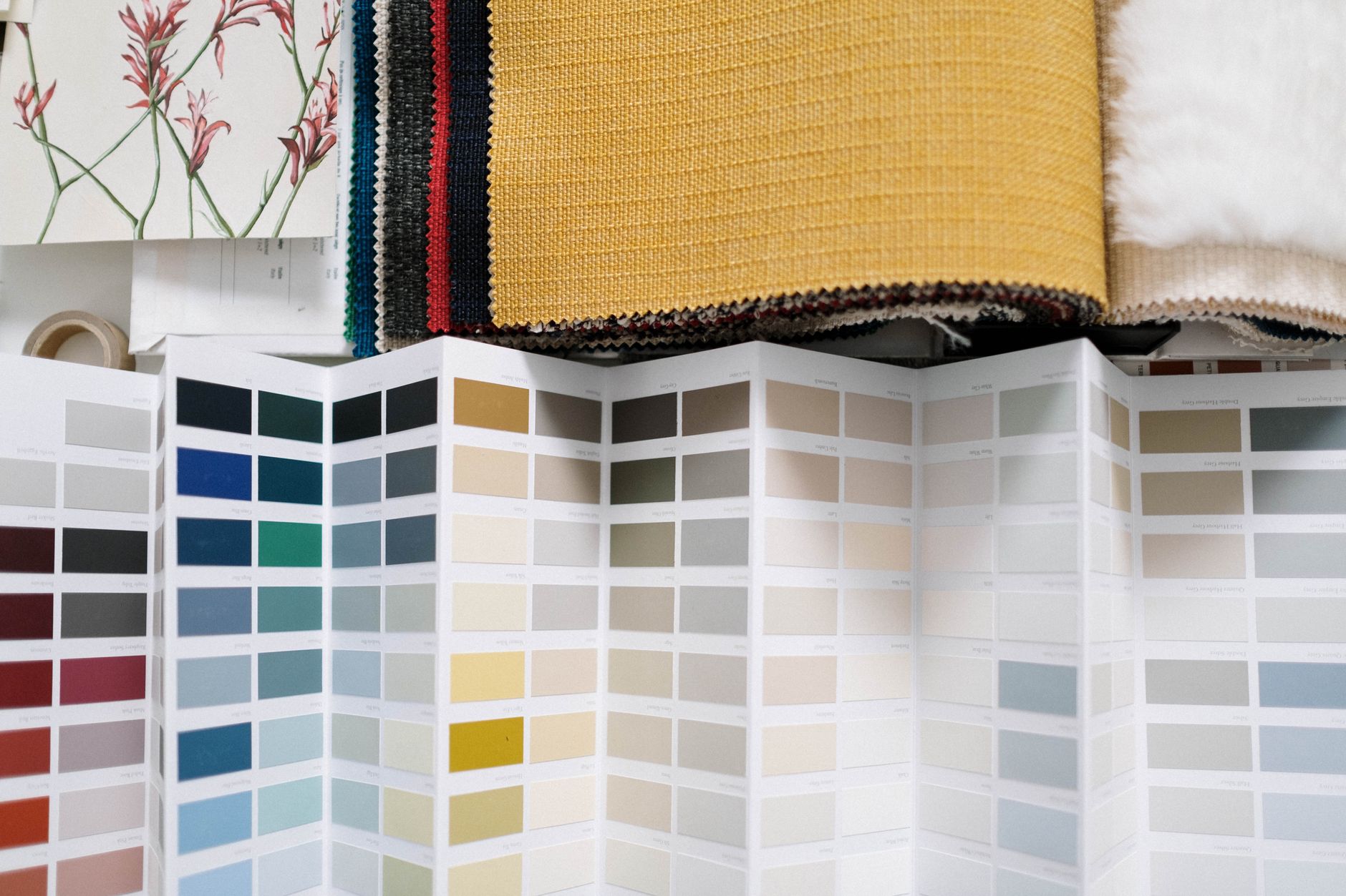 A variety of fabric swatches alongside a detailed color palette for design inspiration.