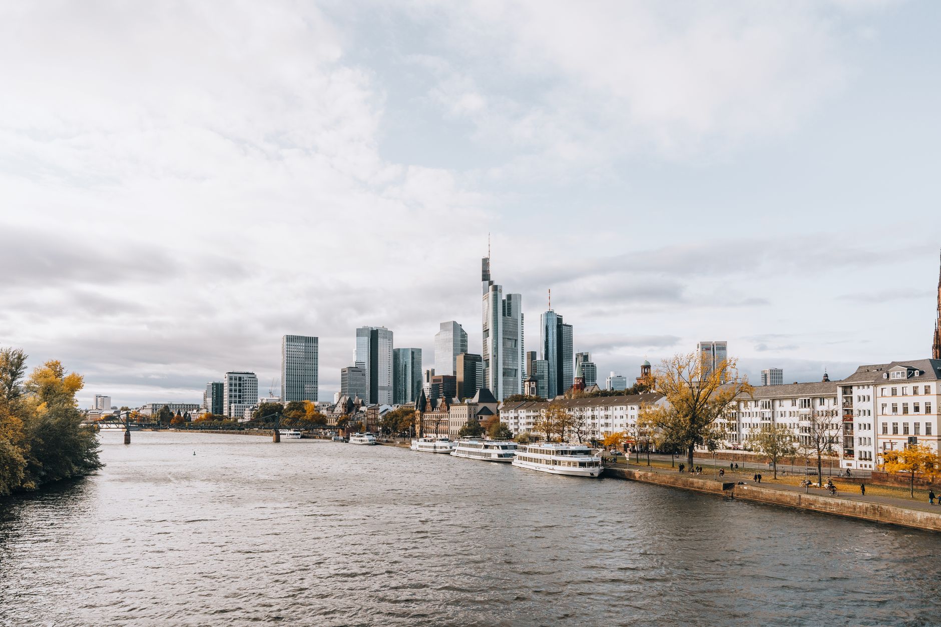 Captivating view of Frankfurt's modern skyline alongside the river during autumn.