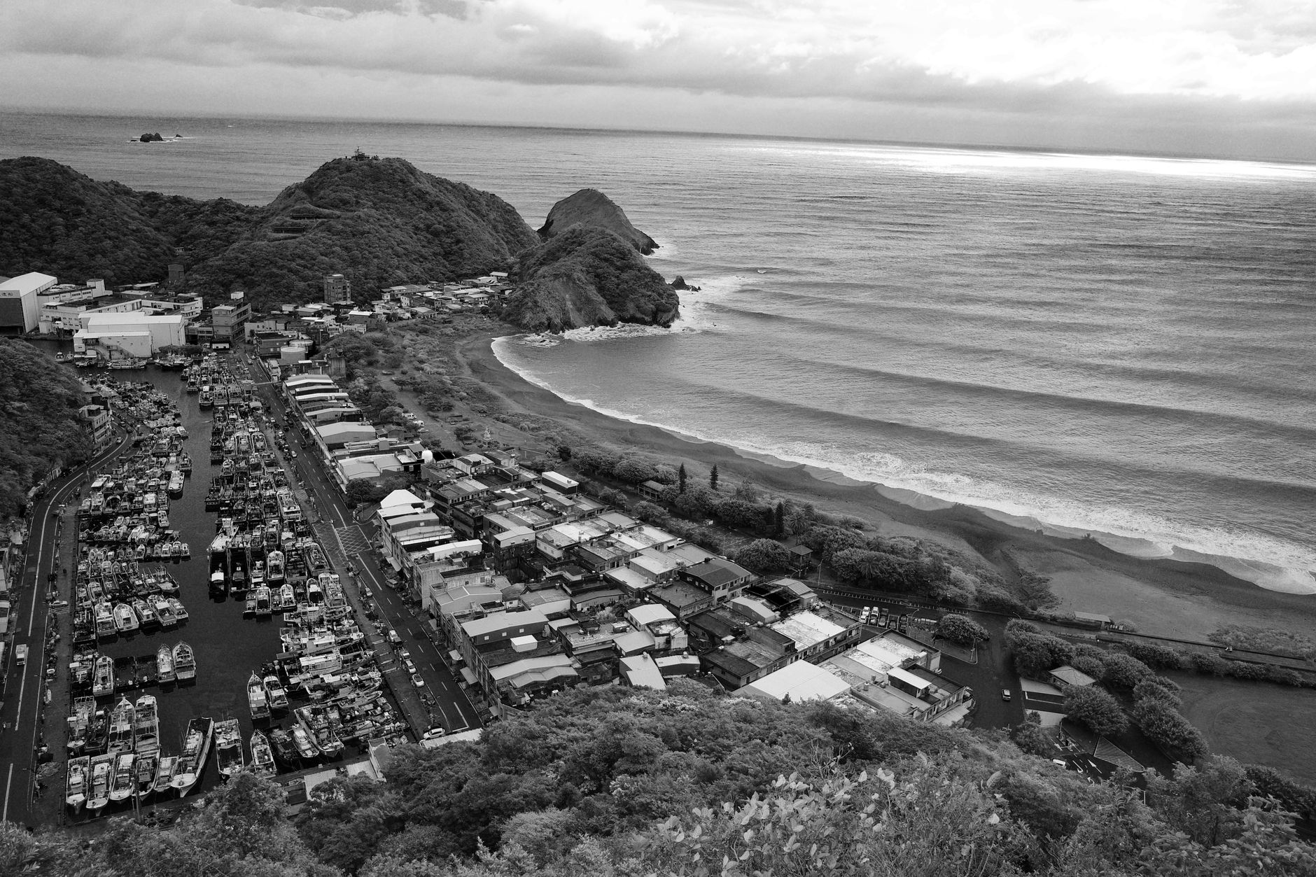 A captivating black and white aerial view of Yilan County, Taiwan coastline, featuring a marina and surrounding landscape.