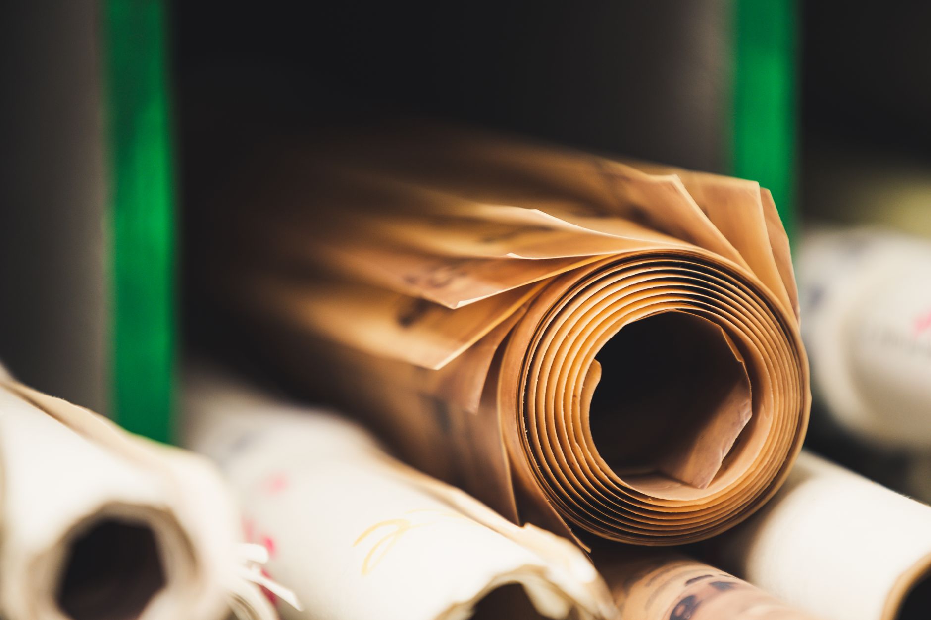 Stack of various multicolored paper rolls placed together inside shelf with dividers