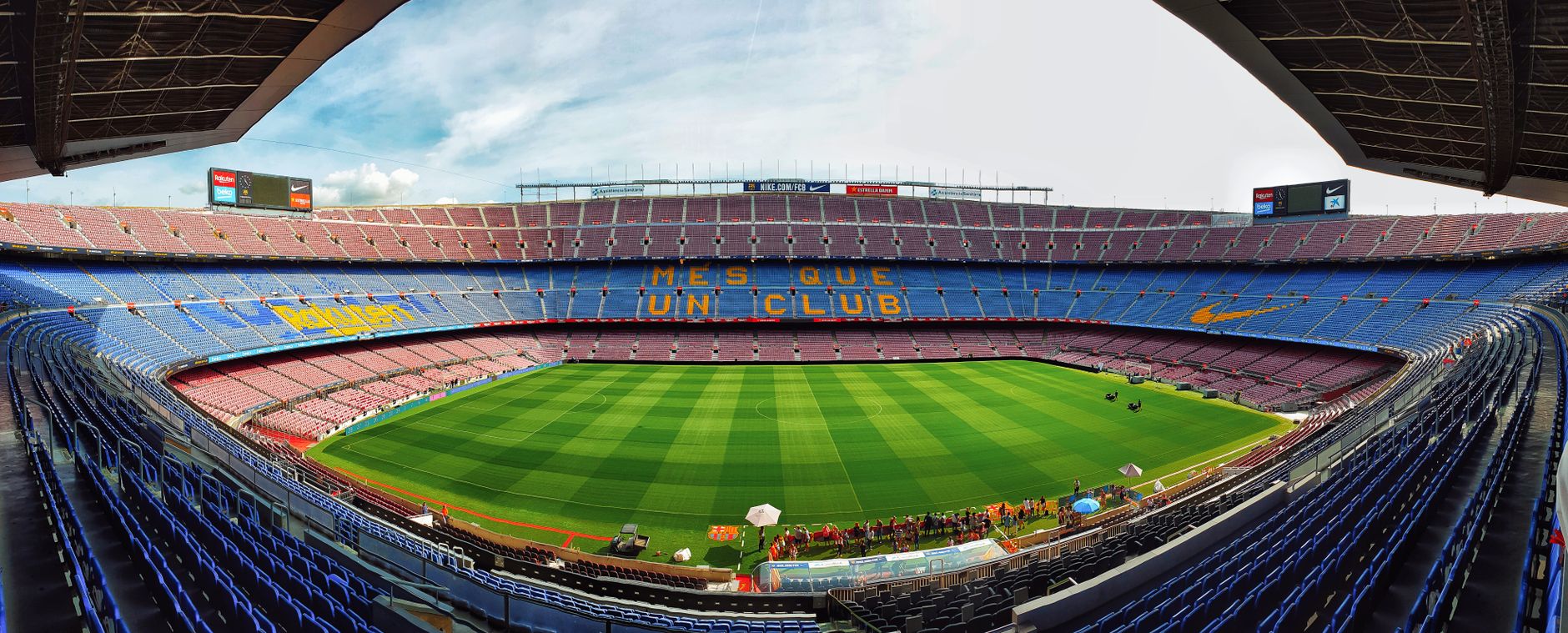 A wide-angle view of the iconic Camp Nou stadium, home to FC Barcelona, with empty bleachers.