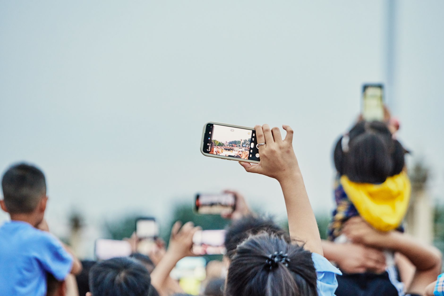 A lively crowd capturing an event on smartphones, showcasing modern digital engagement.