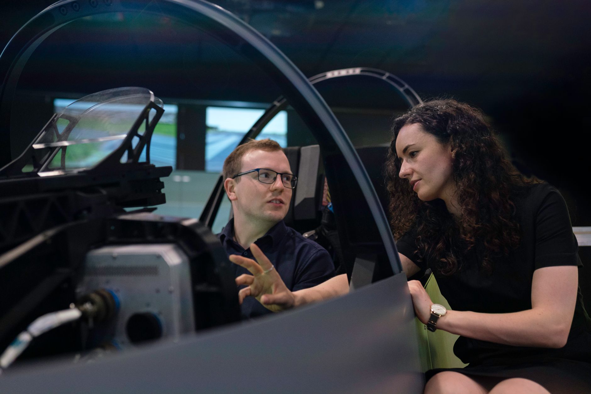 Engineers analyzing aircraft cockpit design during a simulation session.
