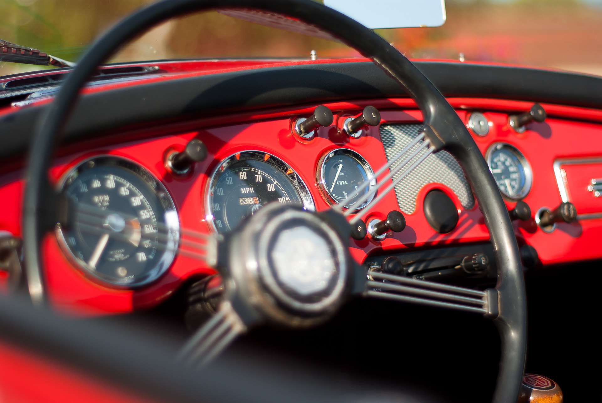 500px provided description: Mg Cabriolet [#car ,#rouge ,#voiture ,#volant ,#voiture de collection ,#MG ,#tableau de bord ,#compteur de vitesse]