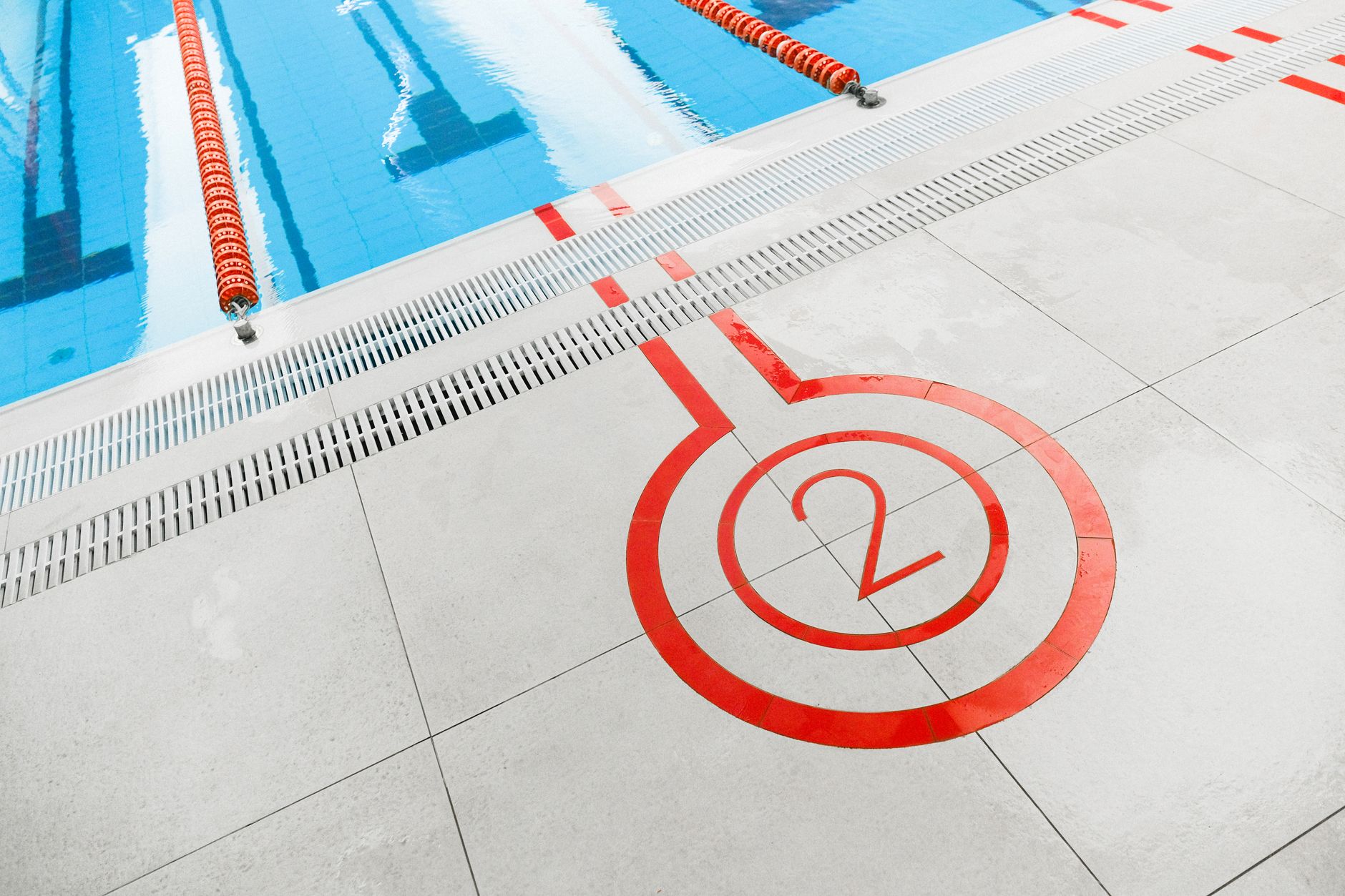 Close-up of the number two marking beside an outdoor swimming pool lane.
