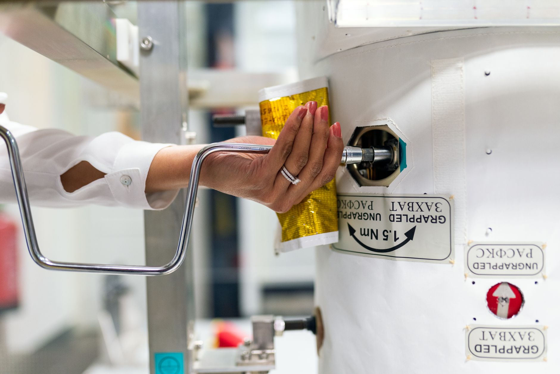 A female scientist adjusts laboratory equipment for a research experiment.