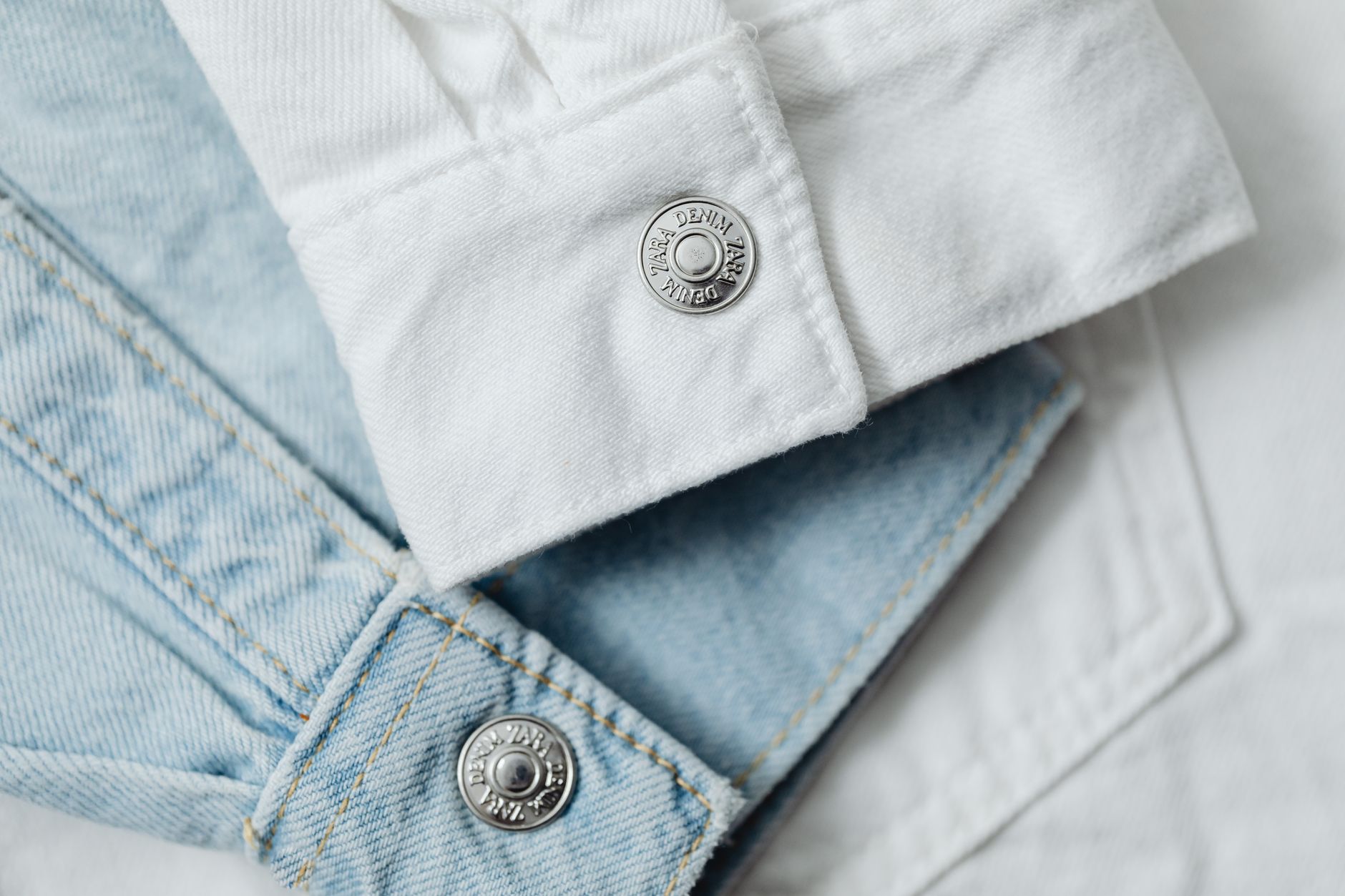 Close-up of stylish white and light blue denim fabric showcasing details and textures.