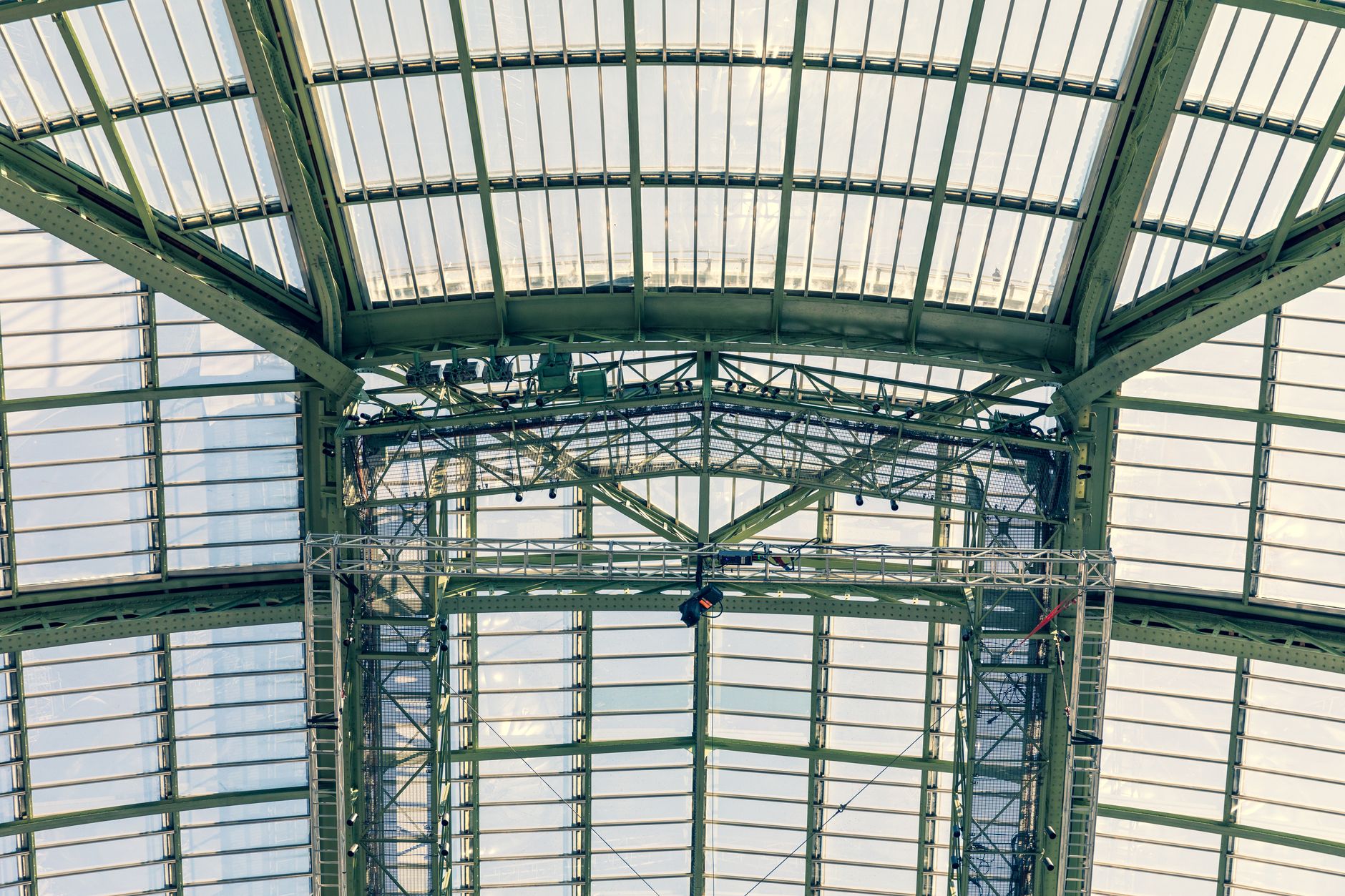 The intricate glass roof of Grand Palais in Paris, showcasing its architectural beauty.