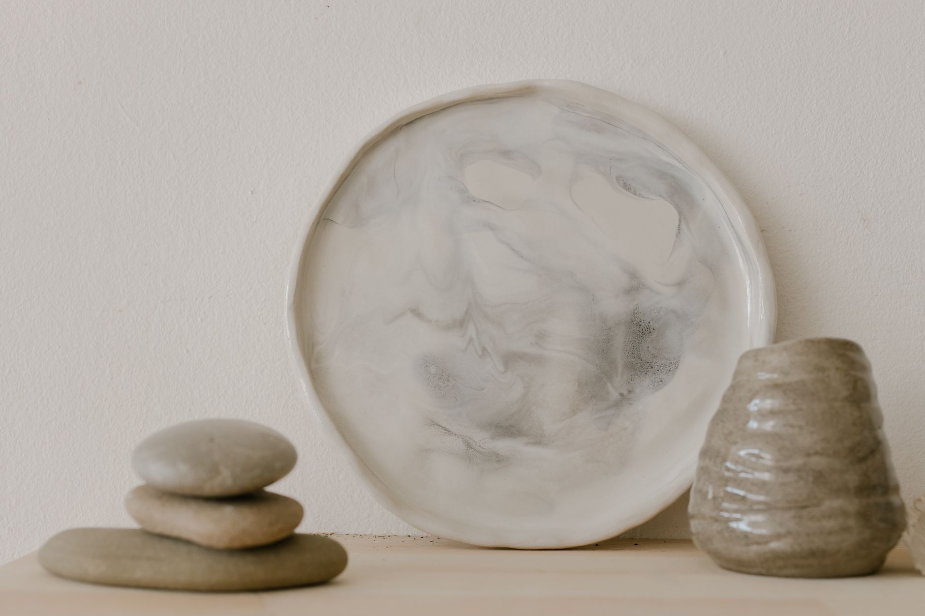 Objets en céramique artisanale disposés sur une table intérieure.