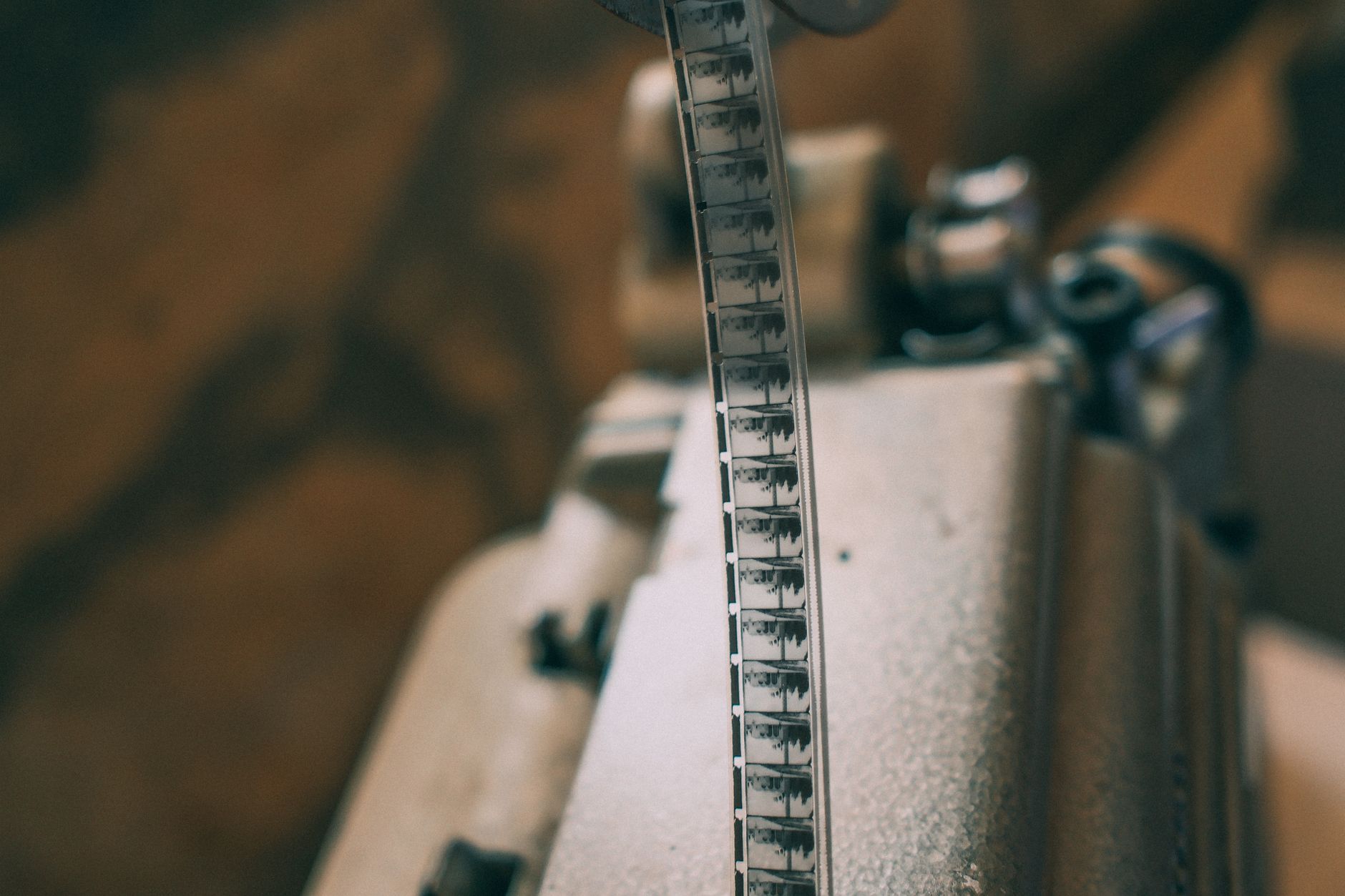 Close-up of a vintage film strip on a projector, showcasing classic cinema.